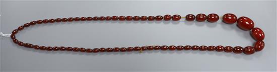 A single strand simulated cherry amber oval bead necklace, gross weight 93 grams, 100cm.